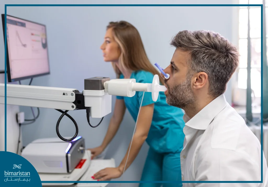 رجل يجري اختبار وظائف الرئة باستخدام جهاز قياس التنفس بمساعدة مختصة صحية